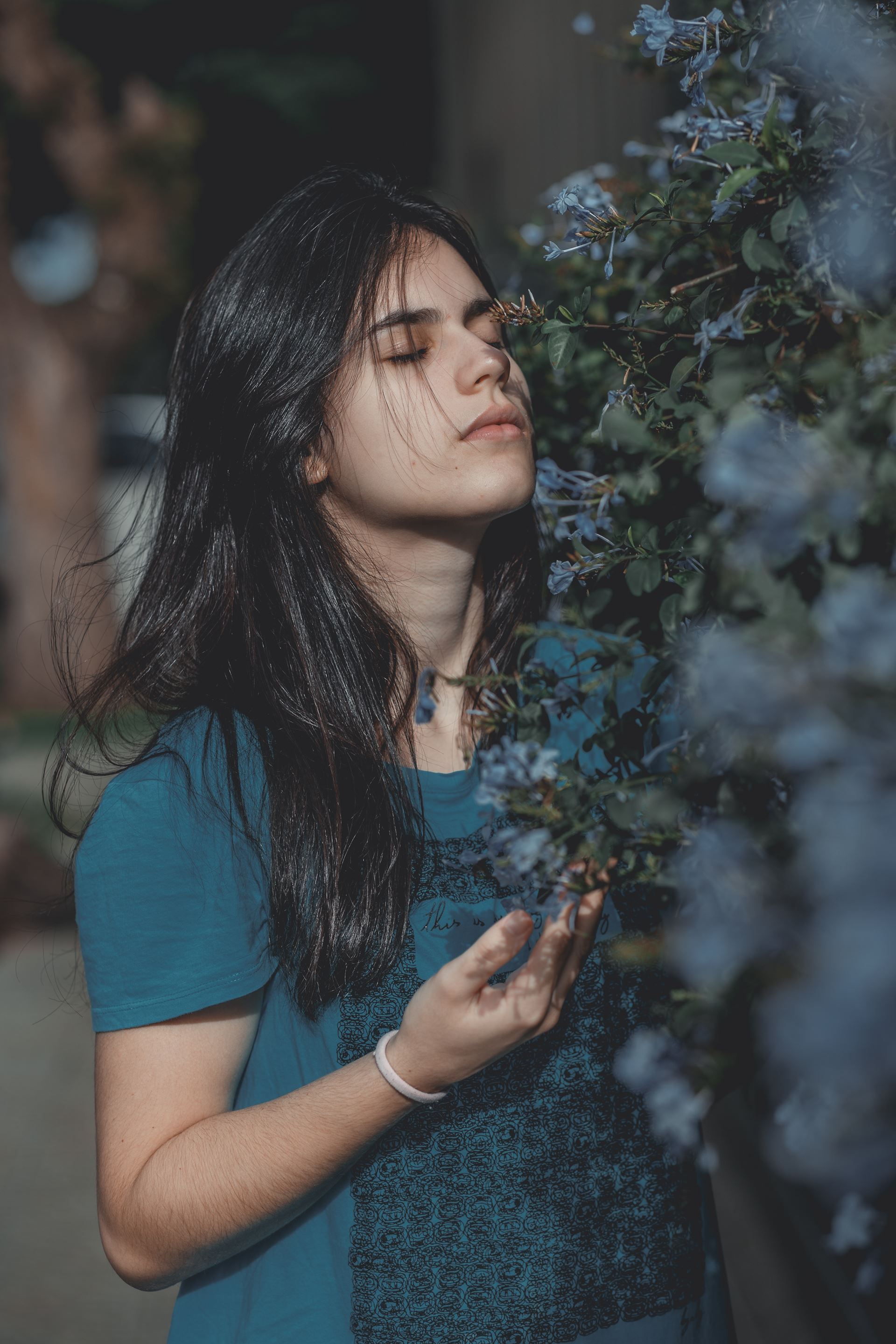 a person smelling a plant